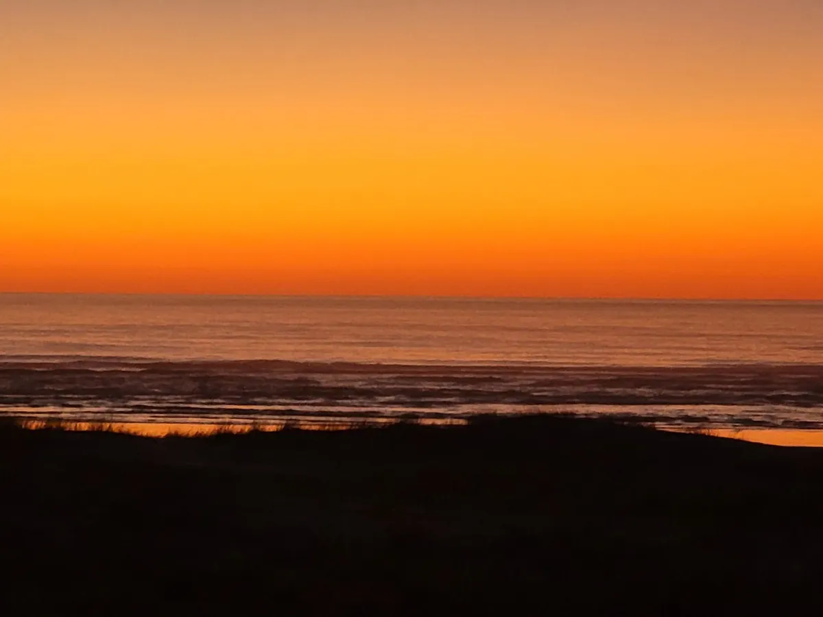 Golden Pacific sunset seen from Beach Escape in Waldport